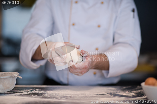 Image of chef hands preparing dough for pizza