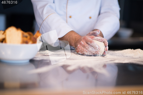 Image of chef hands preparing dough for pizza