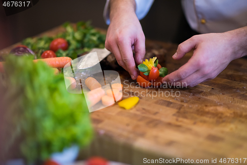 Image of closeup of Chef hands preparing beef steak