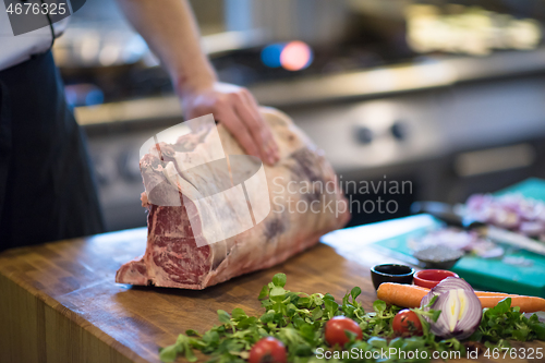 Image of chef cutting big piece of beef