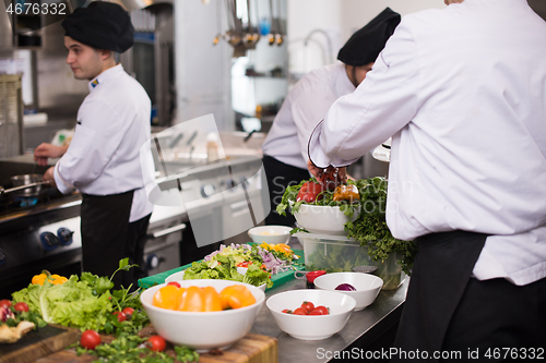 Image of team cooks and chefs preparing meals