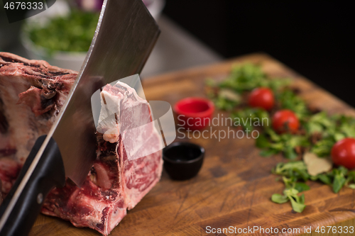 Image of chef cutting big piece of beef