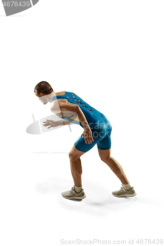 Image of Young caucasian man running or jogging isolated on white studio background.