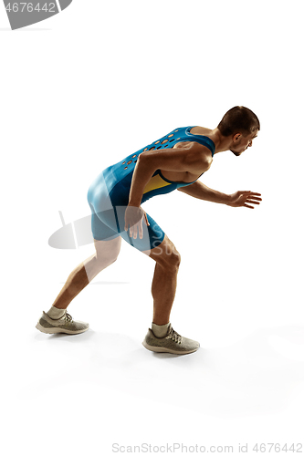 Image of Young caucasian man running or jogging isolated on white studio background.