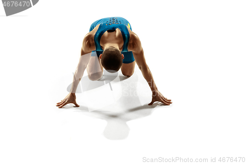 Image of Young caucasian man running or jogging isolated on white studio background.