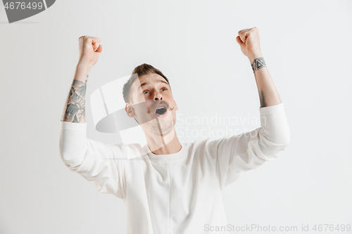 Image of Winning success man happy ecstatic celebrating being a winner. Dynamic energetic image of male model