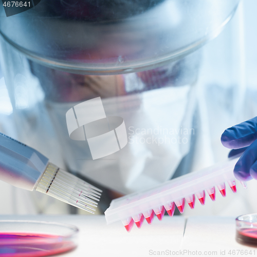 Image of Scientist working in the corona virus vaccine development laboratory research with a highest degree of protection gear.