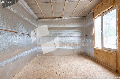 Image of Thermal insulation of a country house, vapor barrier film made of reflective polyethylene foam laminated with lavsan for house insulation