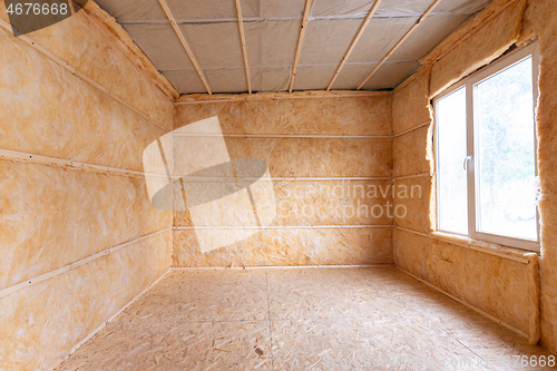 Image of Roll insulation on the inner walls of a small room