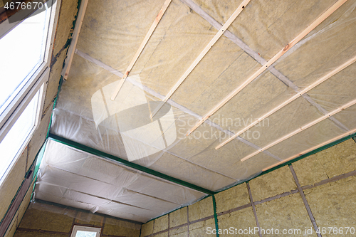 Image of Insulation of the roof from the inside with mineral wool in a wooden country house