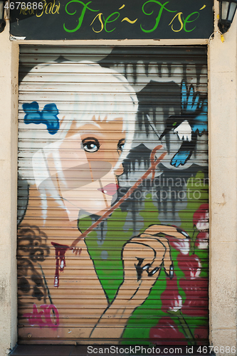 Image of BARCELONA, SPAIN - JUNE 2, 2013: Portrait of a beautiful young blonde girl painted on the door