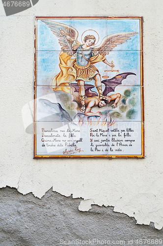 Image of BARCELONA, SPAIN - JUNE 2, 2013: Picture of a mosaic depicting the angel and devil. An image of specially painted tiles and pieces of glaze on the wall of a house in Barcelona
