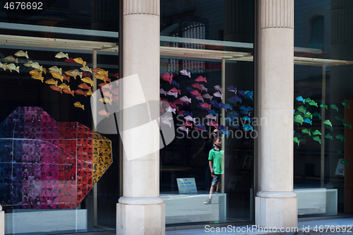 Image of BARCELONA, SPAIN - JUNE 2, 2013: Contemporary gallery showcase with rainbow fish
