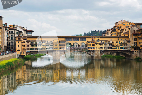 Image of FLORNCE, ITALY - APRIL 24, 2019: Ponte Vecchio. View of the historic buildings in Florence. Reflection in the river