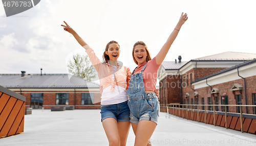 Image of teenage girls or friends on city roof top