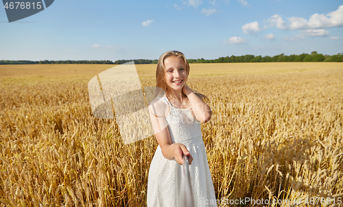 Image of happy girl taking selfie on cereal field