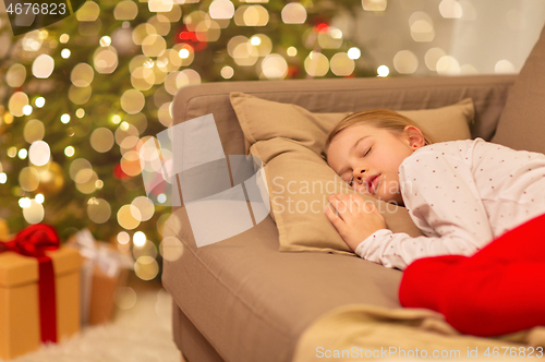 Image of girl sleeping on sofa at christmas