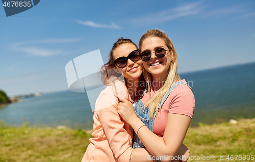 Image of teenage girls or best friends at seaside in summer