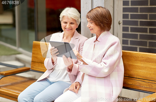 Image of senior women with tablet computer in city