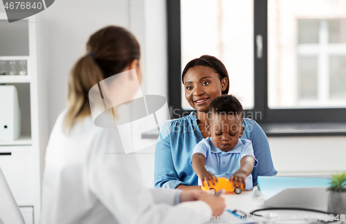 Image of happy mother with baby son and doctor at clinic