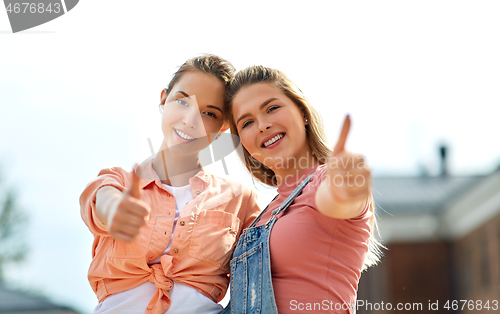Image of teenage girls or best friend showing thumbs up