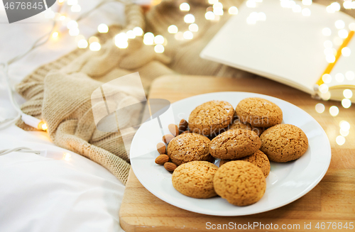 Image of oatmeal cookies with almonds on plate at home