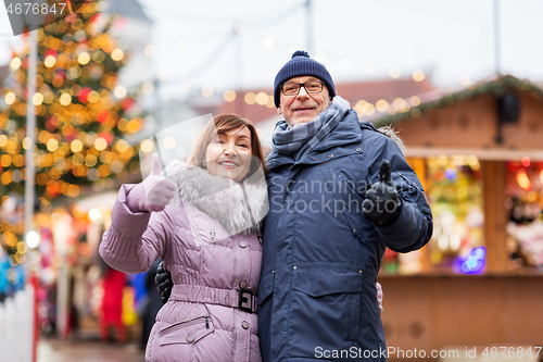 Image of senior couple shows thumbs up at christmas market