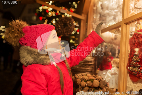 Image of girl choosing christmas decorations at market