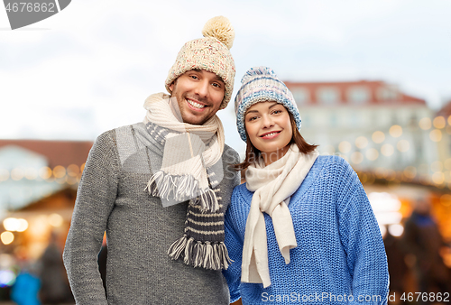 Image of happy couple in winter clothes at christmas market