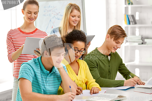 Image of students with notebooks and tablet pc at school