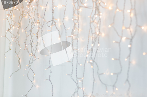 Image of christmas garland lights over grey background