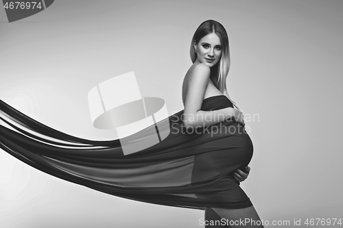 Image of Pregnant girl in red dress