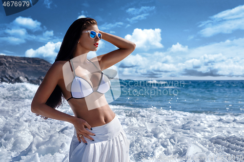 Image of beautiful girl  in white bikini at seaside