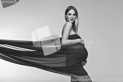 Image of Pregnant girl in red dress