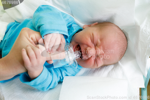 Image of crying newborn baby infant in the hospital