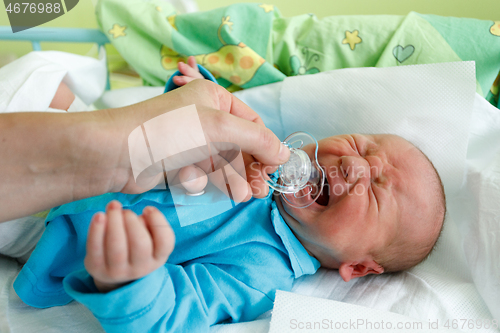 Image of crying newborn baby infant in the hospital