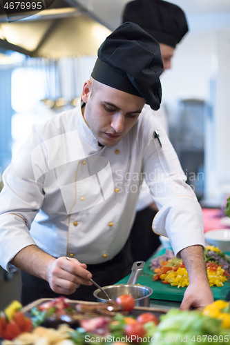 Image of Chef finishing steak meat plate