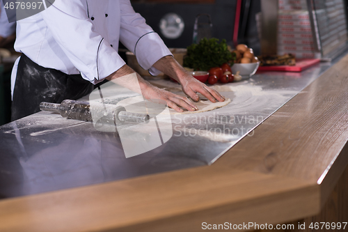 Image of chef preparing dough for pizza