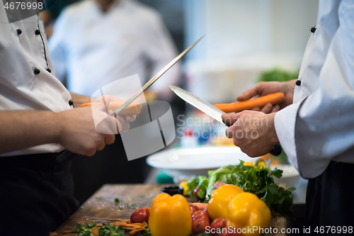 Image of chefs hands cutting carrots