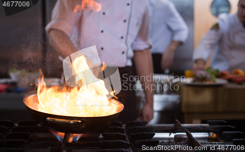 Image of Chef doing flambe on food