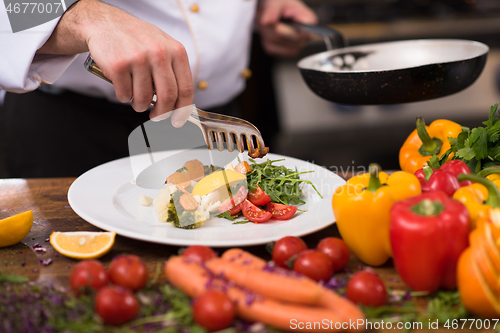 Image of chef serving vegetable salad