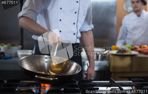 Image of Chef doing flambe on food