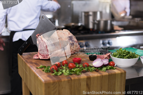 Image of chef cutting big piece of beef