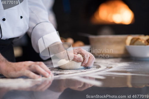 Image of chef hands preparing dough for pizza