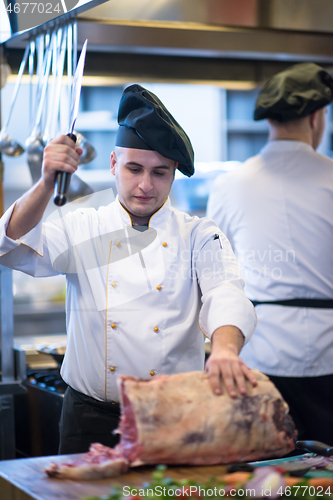 Image of chef cutting big piece of beef