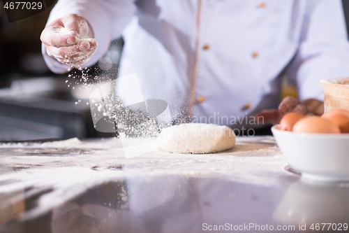 Image of chef hands preparing dough for pizza