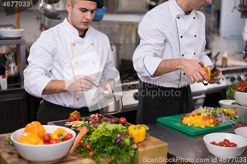 Image of team cooks and chefs preparing meals