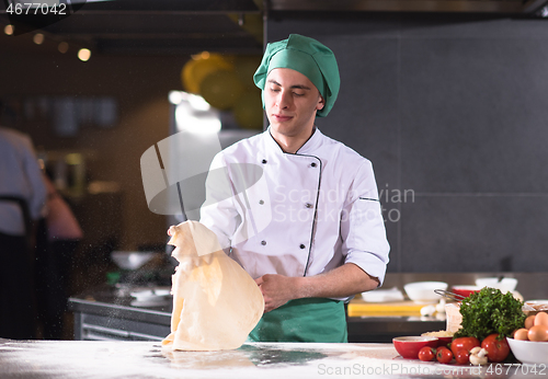 Image of chef throwing up pizza dough