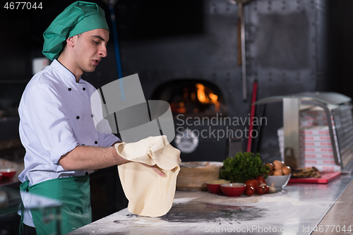 Image of chef preparing dough for pizza