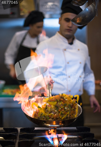 Image of Chef doing flambe on food